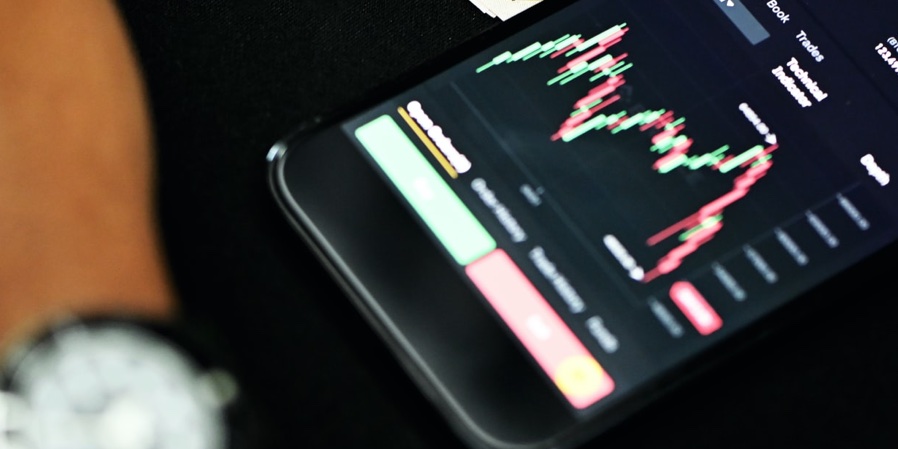 Scalping trading with a mobile phone on a trading app.